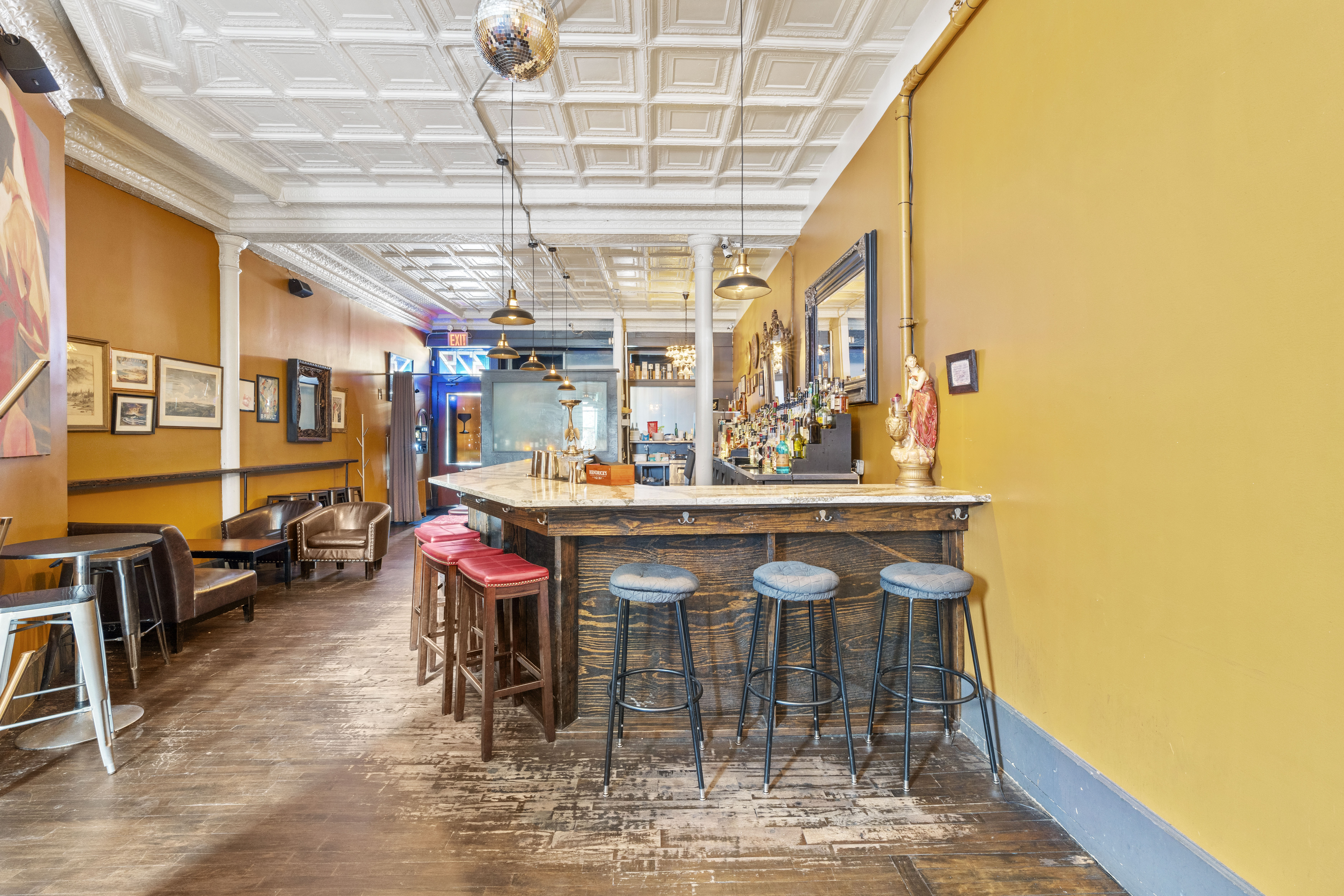 Interior of The Coupe cocktail bar with tin ceilings and seating