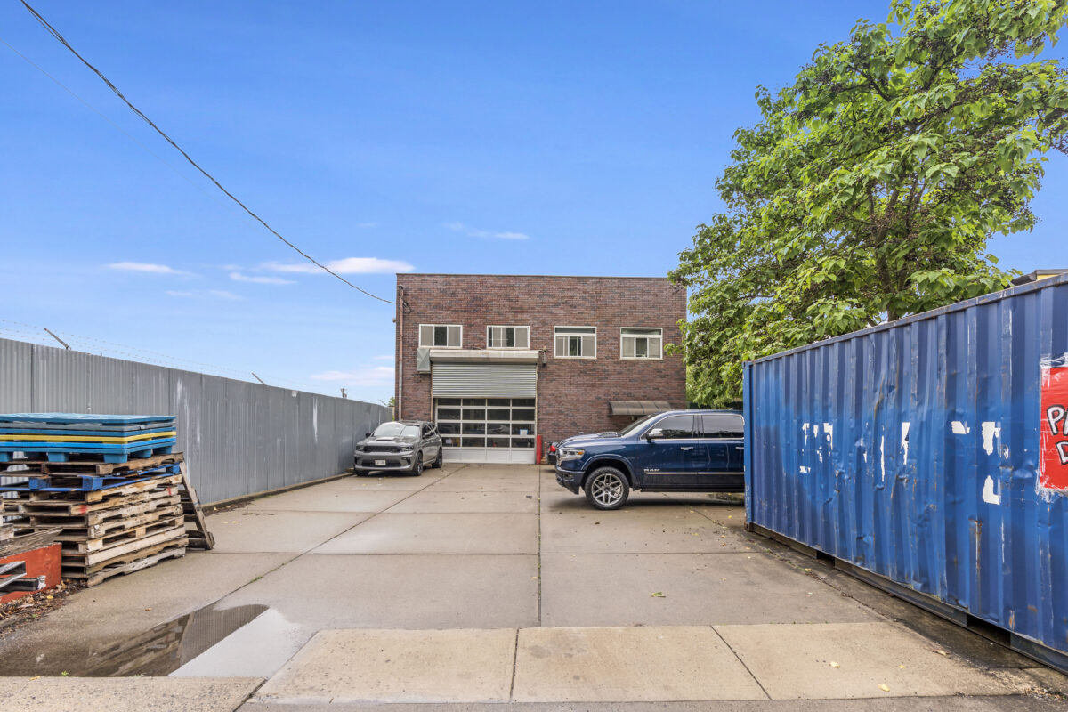 Front view of 574 Industrial Staten Island with paved lot and roll-up entry