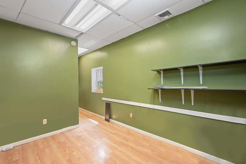 Private room with built-in shelving and green walls